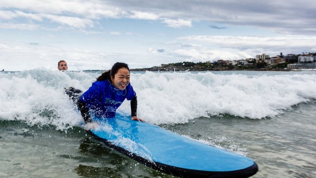 Xiaodan Zhang gets a surfing lesson.