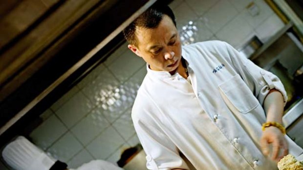 Chinese chef Yu Bo (R) cooks in his restaurant Yu's Family Kitchen in Chengdu.