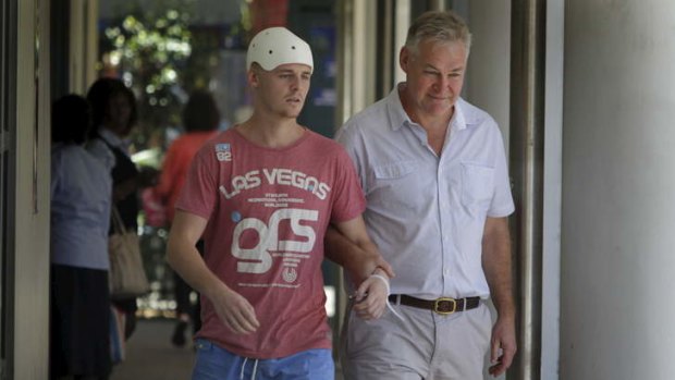 Michael McEwen leaves St Vincent's Hospital with his father, Robert.