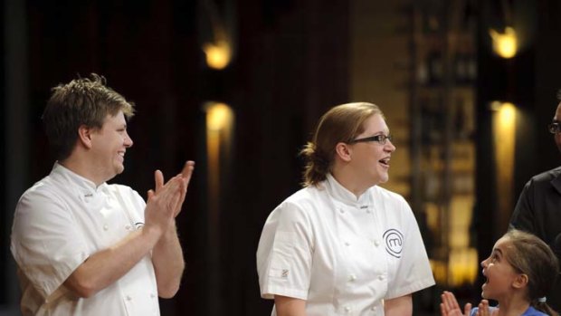 Runner-up Michael Weldon applauds Kate Bracks, along with Kate's daughter Erin, after she was last night dubbed Australia's MasterChef.
