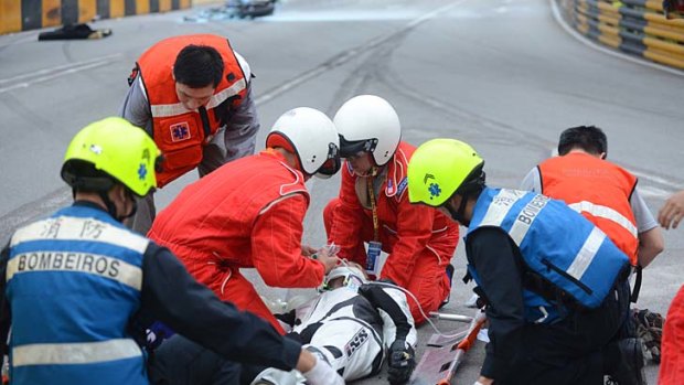 Luis Filipe de Sousa Carreira receives medial attention after he crashed during qualifying for the Macau Grand Prix.