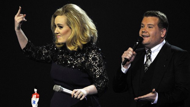 Adele raises her middle finger after being cut while giving an acceptance speech.