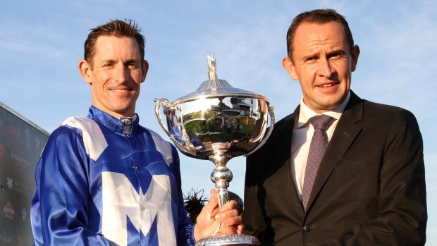 Hugh Bowman and Chris Waller celebrate after winning the Queensland Oaks with Winx. 