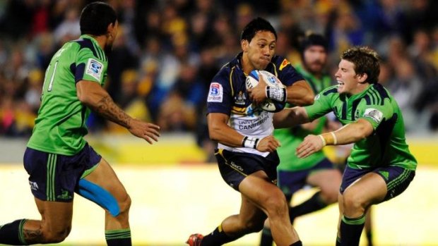 Christian Lealiifano, centre, takes on two Highlanders during their last visit to Canberra.