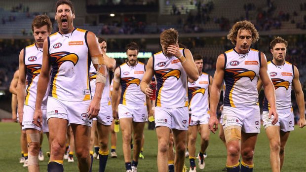The Eagles players walk off after their defeat against Western Bulldogs.