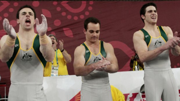 Breaking through ... Australia's Joshua Jefferis, Thomas Pichler and Samuel Offord react after Australia takes the gold medal in the men's gymnastics team final.