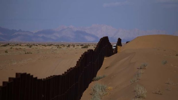 Shift in migration patterns ... a US border patrol vehicle drives along the US-Mexico border fence in Arizona. More Mexicans are now leaving the US than are trying to enter the country.