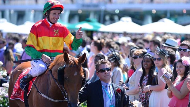 Happy days: Damien Oliver, pictured on Happy Trails after winning the Emirates Stakes, has been banned for 10 months.