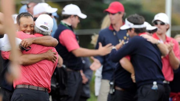 Out of the woods &#8230; Tiger Woods celebrates with captain Fred Couples after the US won the Presidents Cup on his  match with Aaron Baddeley, signalling a return to form for the former world No. 1.