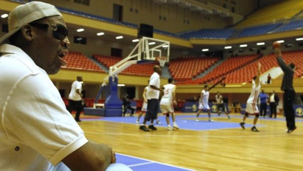Dennis Rodman watches as North Korean and US basketball players practice in Pyongyang.