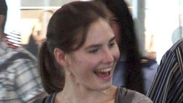 All smiles ... Amanda Knox prepares to fly back to Seattle.