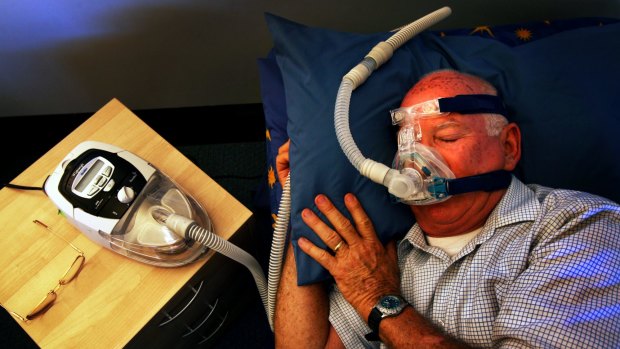 Cliff George with a CPAP machine at an AirLiquide Health fitting room. He says the machine, which helps him breathe while he sleeps, has saved his life by helping him deal with sleep apnoea . 