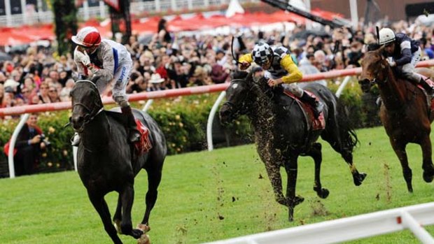 Raider ... Gerard Mosse salutes on Americain in the Melbourne Cup.