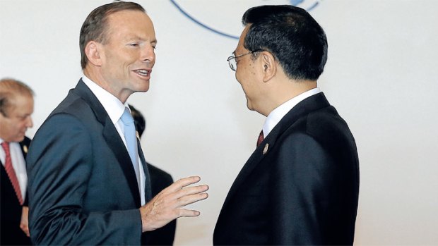 Tony Abbott greets Chinese Premier Li Keqiang at the Boao business forum. <i>Photo: Alex Ellinghausen</i>