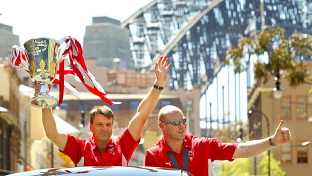 Step back in time ... Former Swans coach Paul Roos and captain Barry Hall parade the premiership trophy through Sydney in 2005.