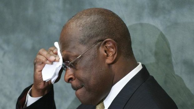 Republican presidential candidate Herman Cain wipes his brow during remarks to legislators in the Congressional Health Care Caucus.