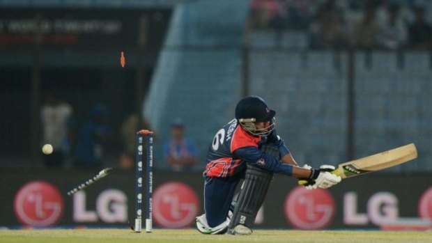Nepal cricketer Naresh Budayair is bowled by Hong Kong cricketer Haseeb Amjad during the ICC Twenty20 World Cup.