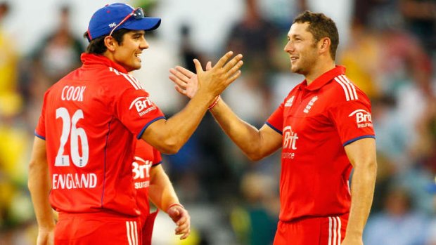 Finally: Alastair Cook and Tim Bresnan of England celebrate Friday night's win.