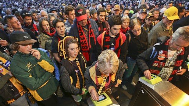 Crowds of people line up at Richmond station as fans are forced to swipe their myki cards.