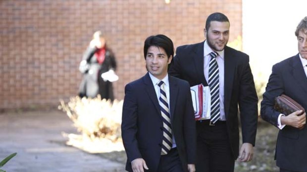 Fadi Ibrahim, front left, and  a member of his legal team leave court yesterday.