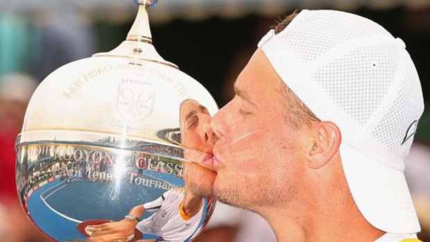Lleyton Hewitt kisses his trophy.