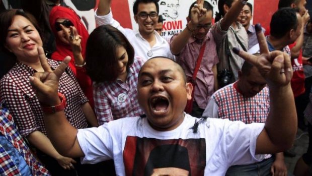 Supporters of Jakarta governor Joko "Jokowi" Widodo celebrate in Makassar, South Sulawesi.
