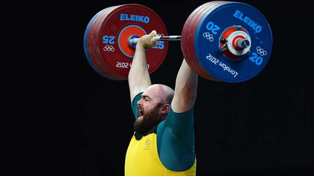 Australia's Damon Kelly lifts during the men's +105kg weightlifting event.
