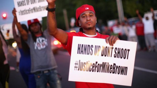Demonstrators protest the killing of teenager Michael Brown outside Greater St. Marks Family Church in Ferguson on Monday.