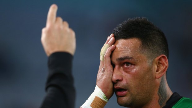Blurred vision: Rabbitohs back-rower John Sutton Rabbitohs receives attention for an eye injury.