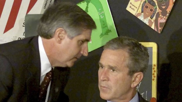 Stunned ... in Florida on September 11, 2001, George Bush is told about the attack.