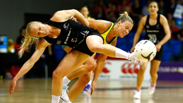 Foot fault: New Zealand's Laura Langman and Australia's Kimberlee Green jostle for possession.