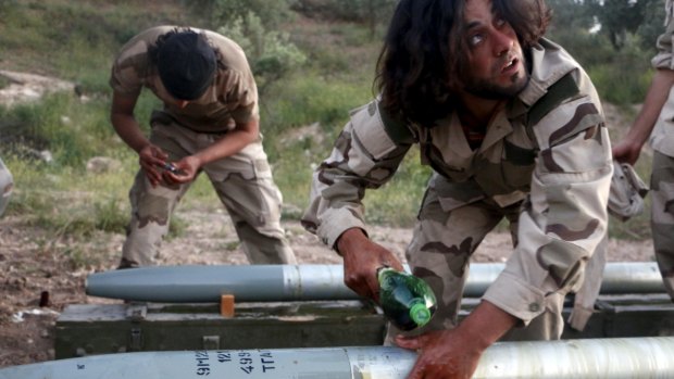 Tajammu Al-Ezza brigade fighters prepare shells to fire at the Assad forces on Friday.