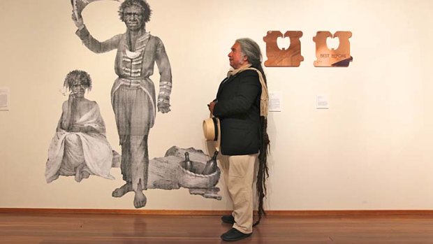 Djon Mundine in front of Bungaree and wife at Mosman Art Gallery.