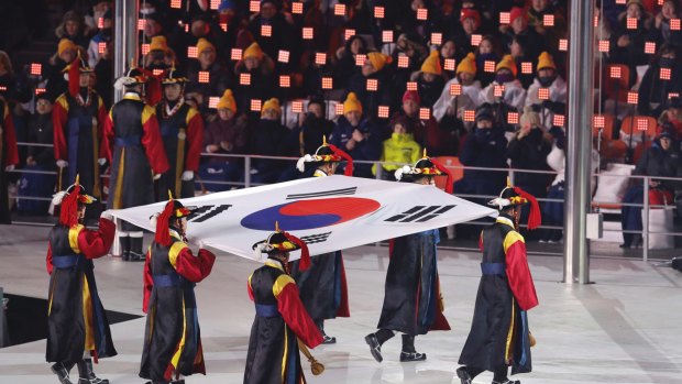 Putting on a show: The South Korea flag is carried into the arena during the opening ceremony of the 2018 Winter Olympics in PyeongChang.