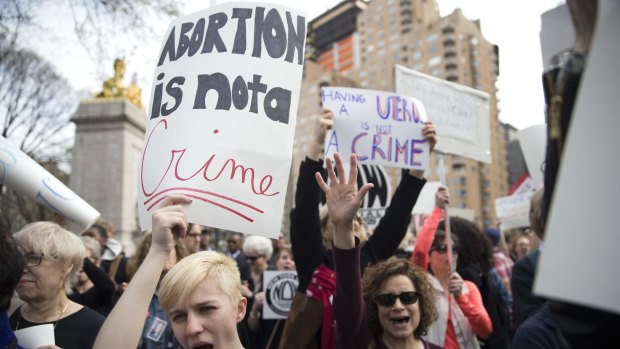 Demonstators at  rally in New York on Thursday protest against Republican presidential candidate Donald Trump's remarks about women and abortion. 