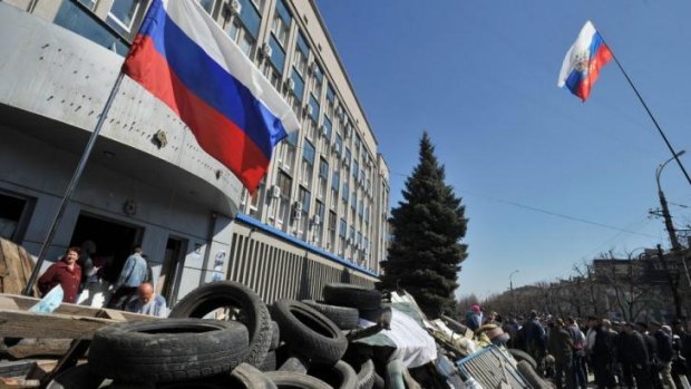 Pro-Russian activists stand guard at a barricade as they block access to the Ukrainian Security Service building in the eastern Ukrainian city of Lugansk.