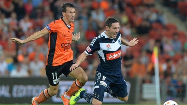 The Roar's Liam Miller was  penalised for this challenge on Victory's Mark Milligan.
