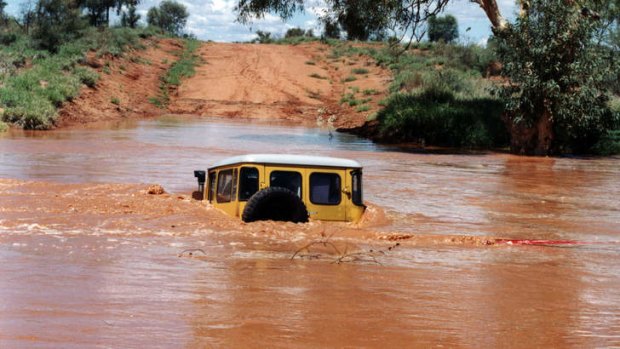 The 4WD sinks beneath the rising river waters.