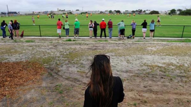 The teenager at the centre of the St Kilda scandal watches the team train at Seaford.
