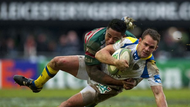 Clermont's Lee Byrne. is tackled by Leicester Tigers centre Manu Tuilagi.