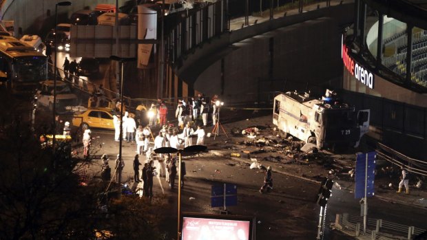 Police forensic officers work after explosions near the Besiktas football club stadium, Vodafone Arena, in Istanbul. 