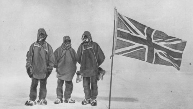 Irish explorer Sir Ernest Henry Shackleton and two members of his expedition team beside a Union Jack within 111 miles of the South Pole, a record feat. Circa 1909.