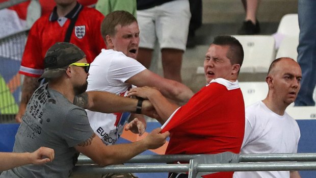 Russian supporters attack an England fan at the end of the Euro 2016 group match between England and Russia, at the Velodrome stadium in Marseille, France.