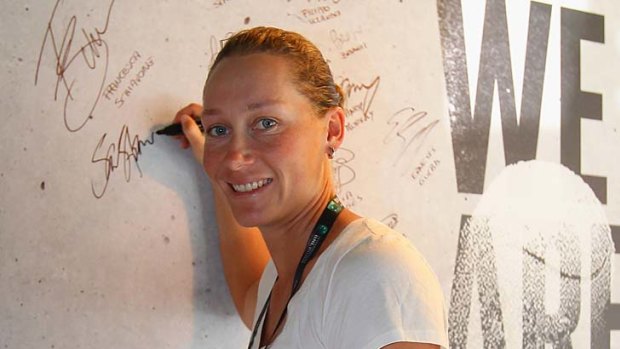 Sam Stosur signs the autograph wall at the Italian Open.