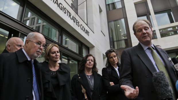 Counting losses ... Vaughan Smith, right, and other backers of Julian Assange talk to the media outside court.
