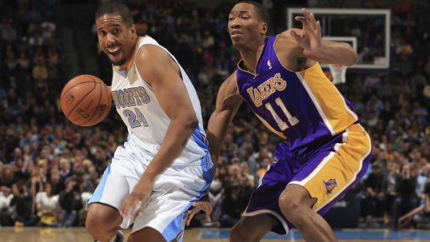 Denver guard Andre Miller controls the ball against Los Angeles Lakers opponent Wesley Johnson. Miller has been traded to the Washington Wizards.
