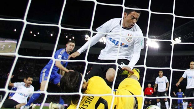 Corinthians' goalkeeper Cassio and teammate Chicao (centre) scramble to stop a shot from Chelsea's Gary Cahill (second left).