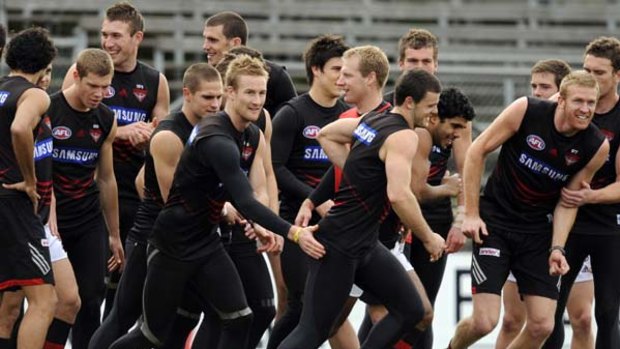Matthew Knights is the centre of attention at Essendon training yesterday.