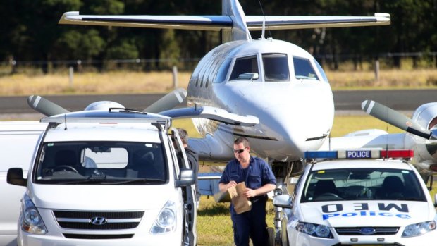 Police raid a plane at Illawarra Regional Airport at Albion Park.