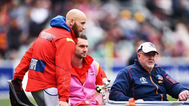 Gold Coast's Gary Ablett is stretchered off the field with a knee injury on Saturday.